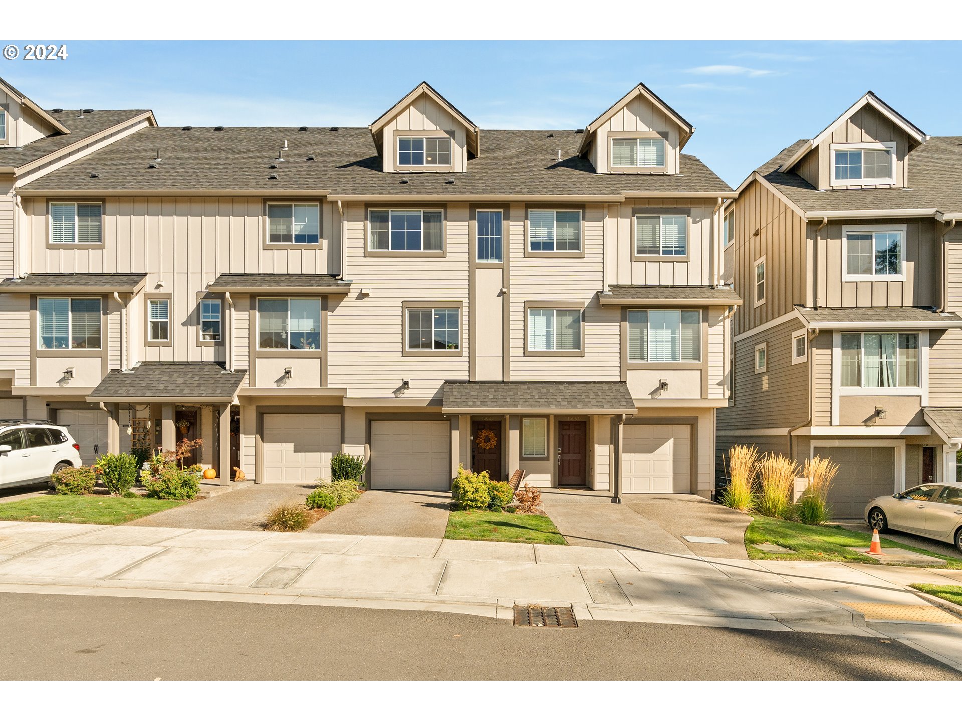 a front view of a residential apartment building with a yard