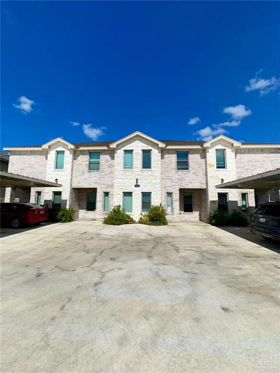 Townhome / multi-family property featuring a carport