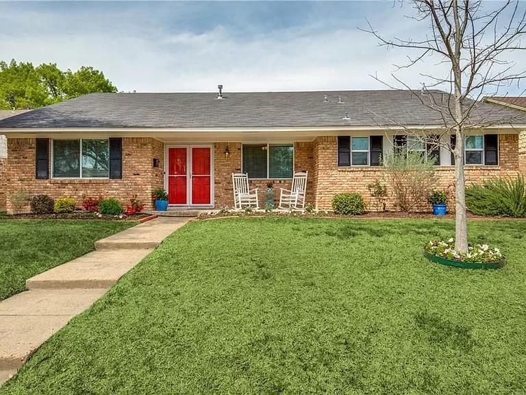 a front view of a house with a yard and porch