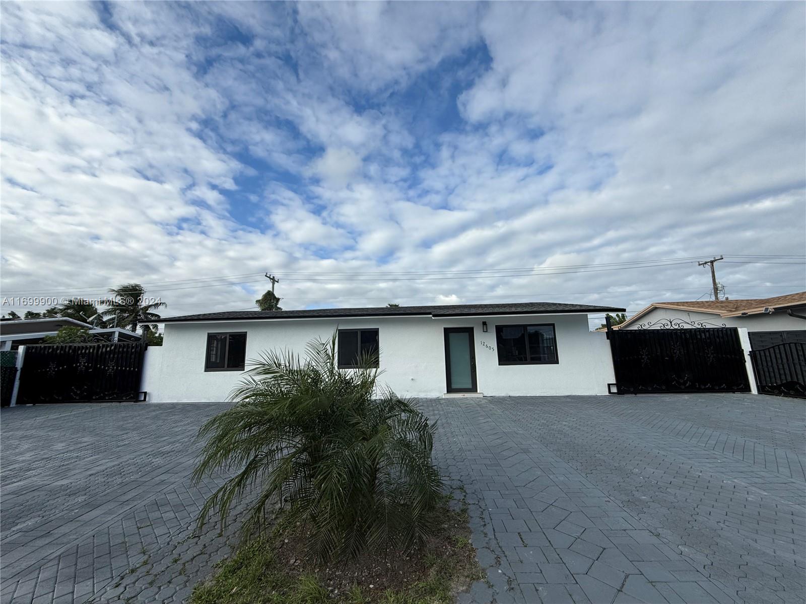 a view of a house with a backyard