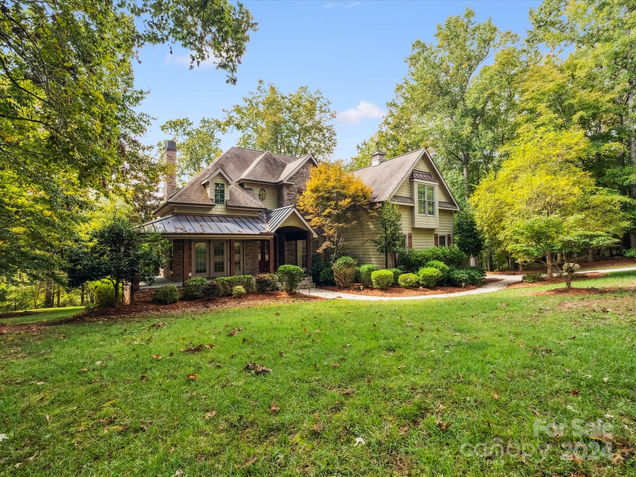 a view of a house with a yard and sitting area