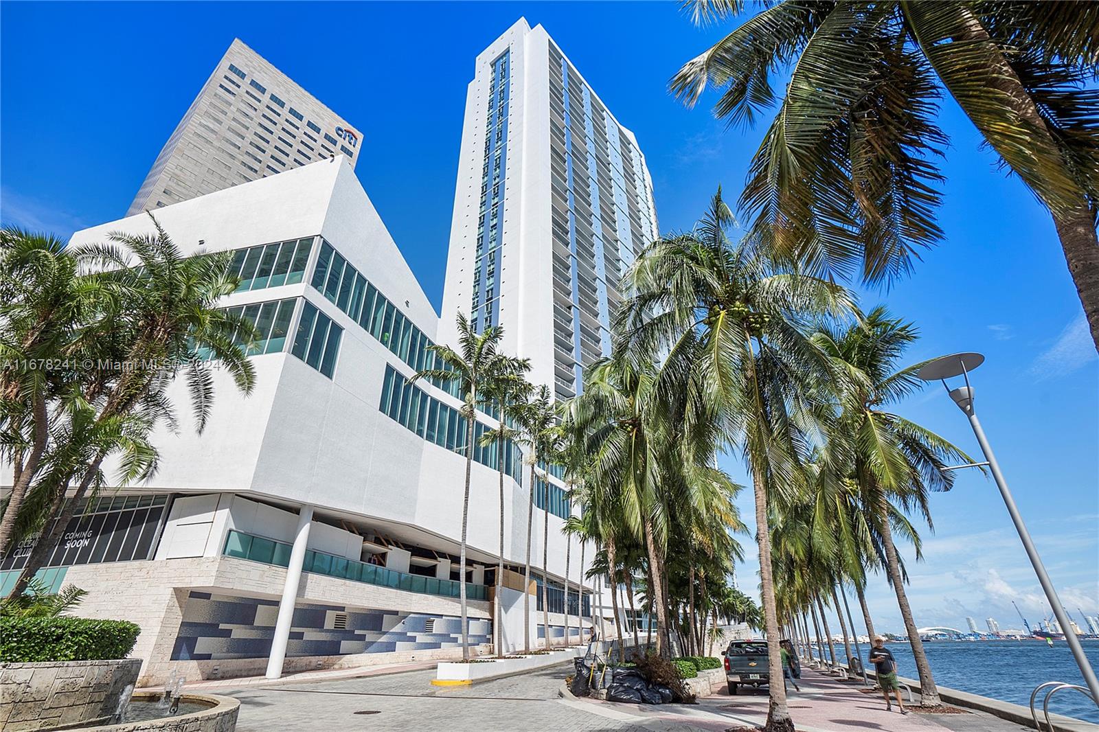 a view of a tall building next to a road