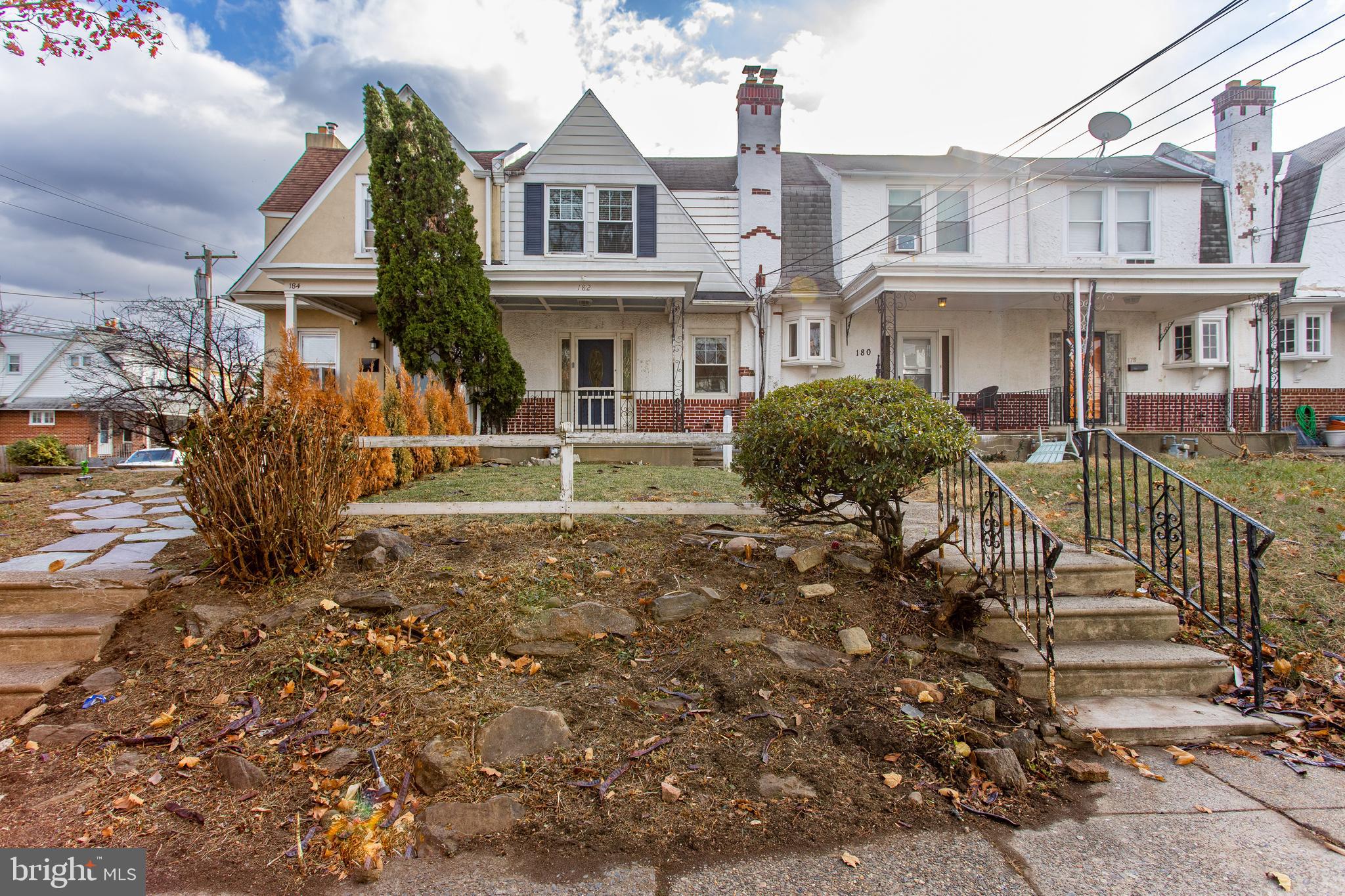 a front view of a residential apartment building with a yard