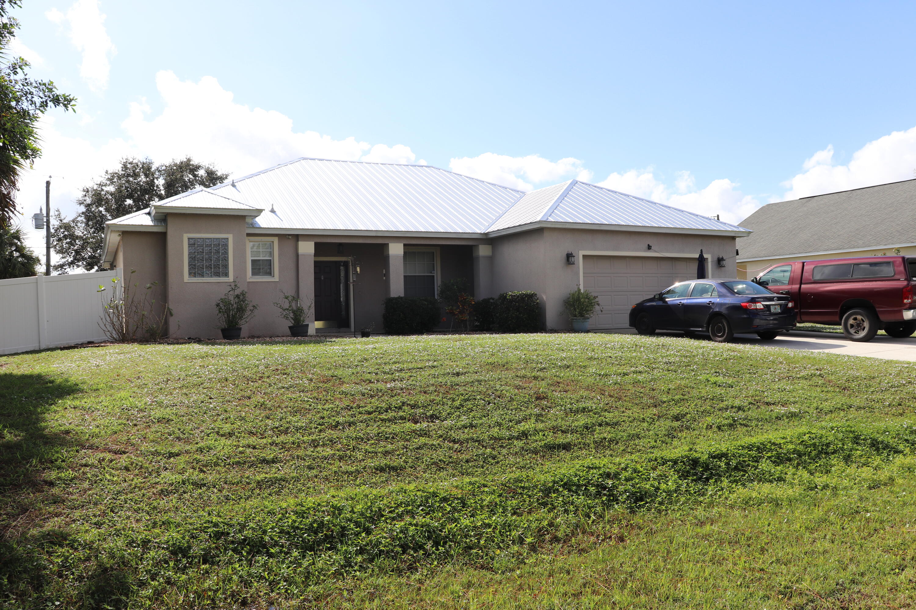 a front view of a house with a garden