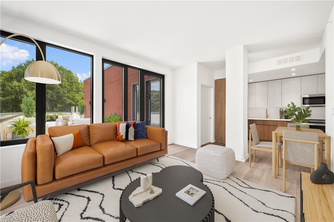 Living room with light hardwood / wood-style floors and sink