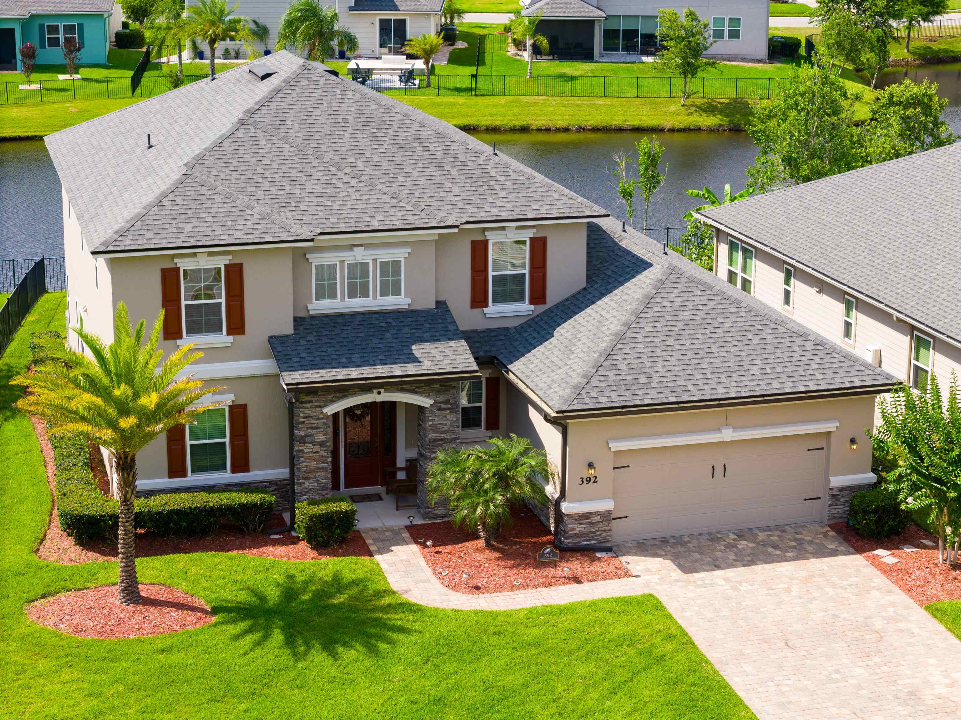 a aerial view of a house with a yard table and chairs