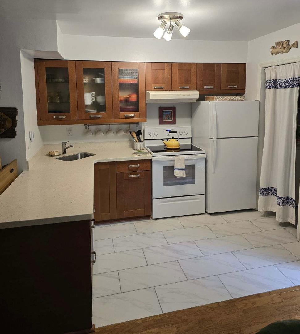 a kitchen with a sink appliances and cabinets