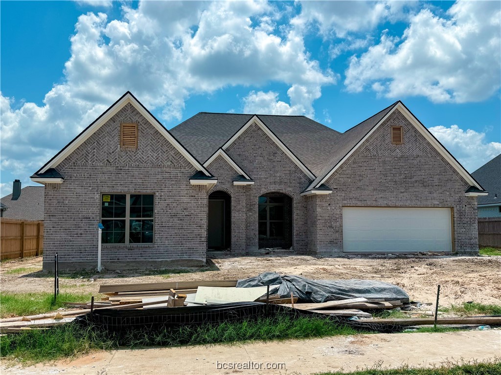 a front view of a house with garage