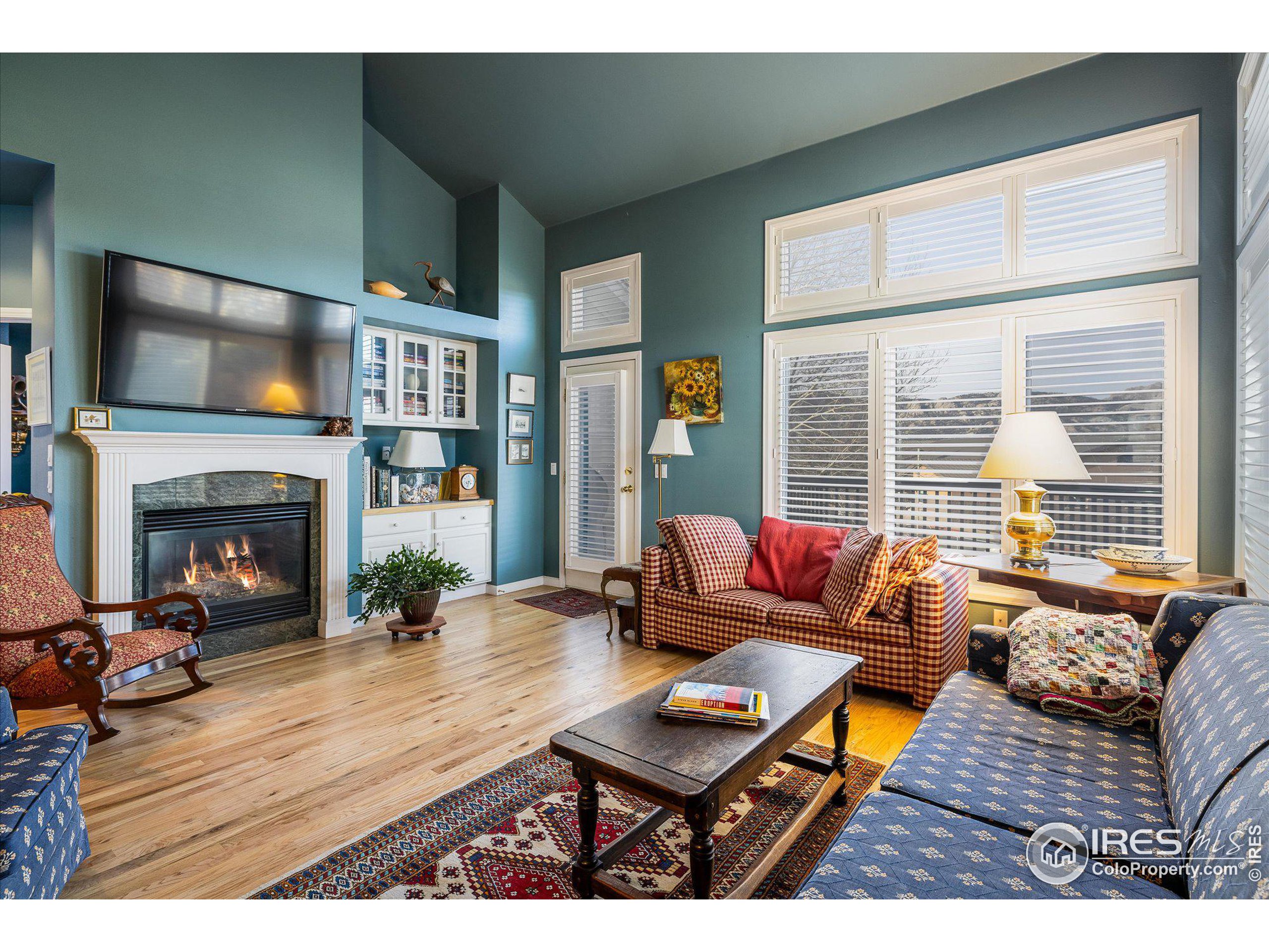 a living room with furniture fireplace and flat screen tv