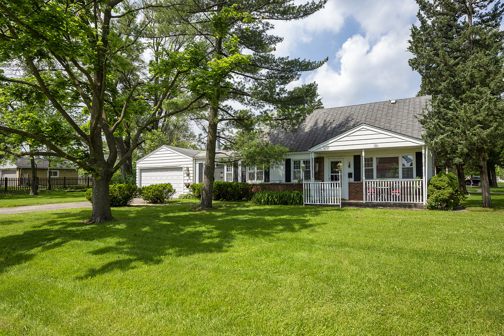 a front view of a house with a garden