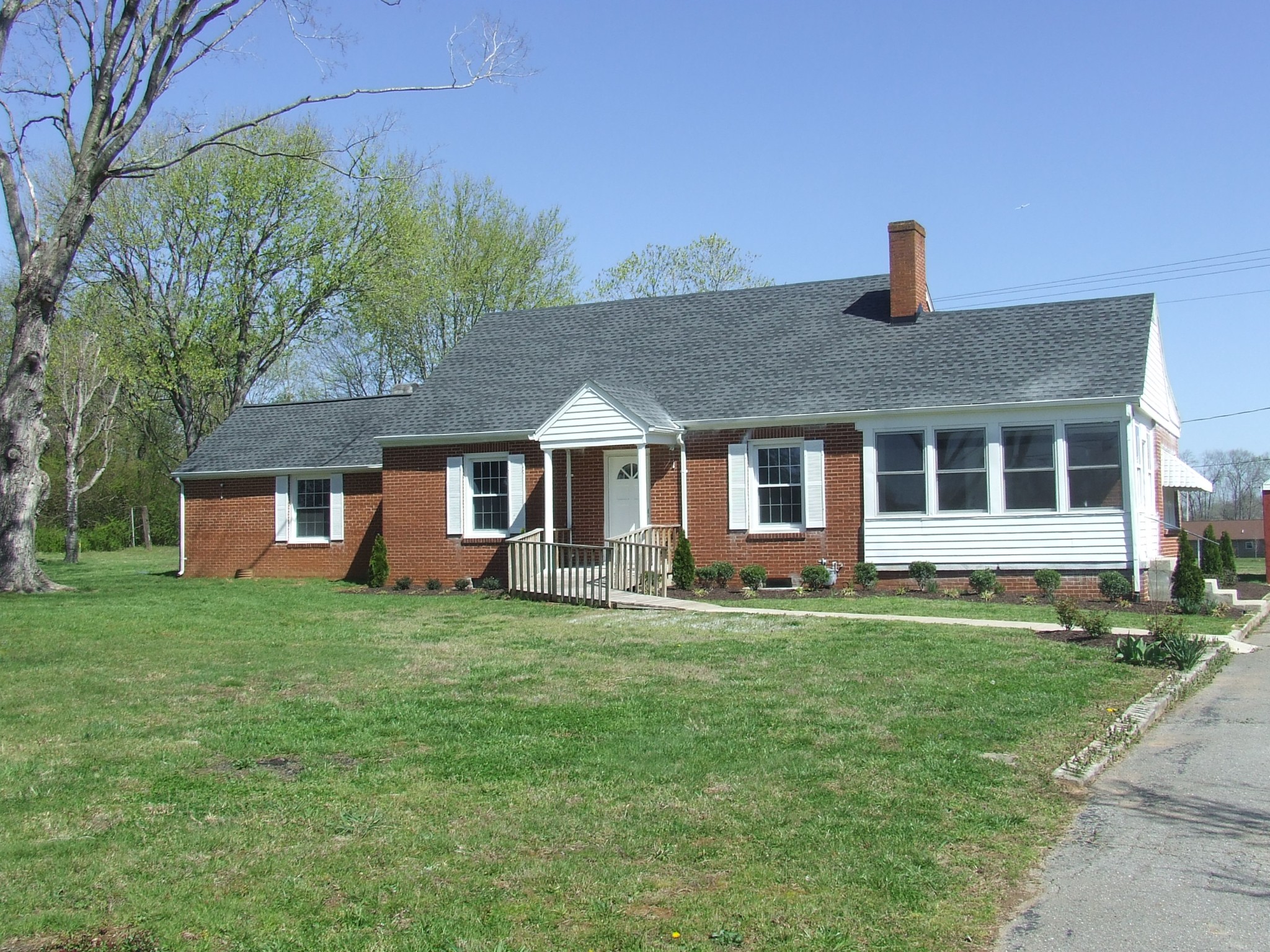 a front view of a house with a garden