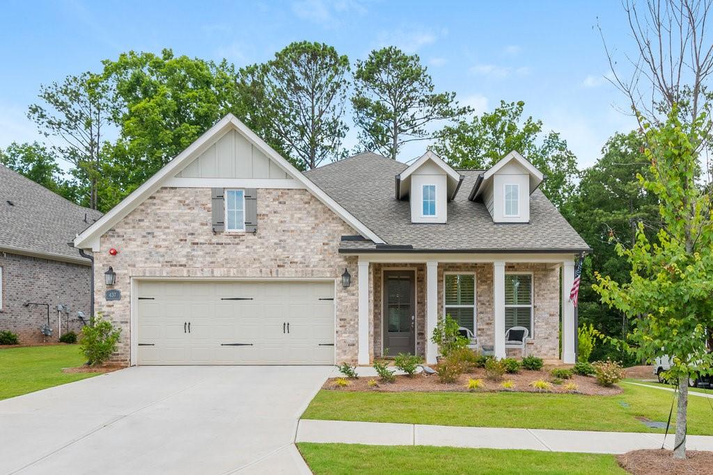 a front view of a house with a yard garage and outdoor seating