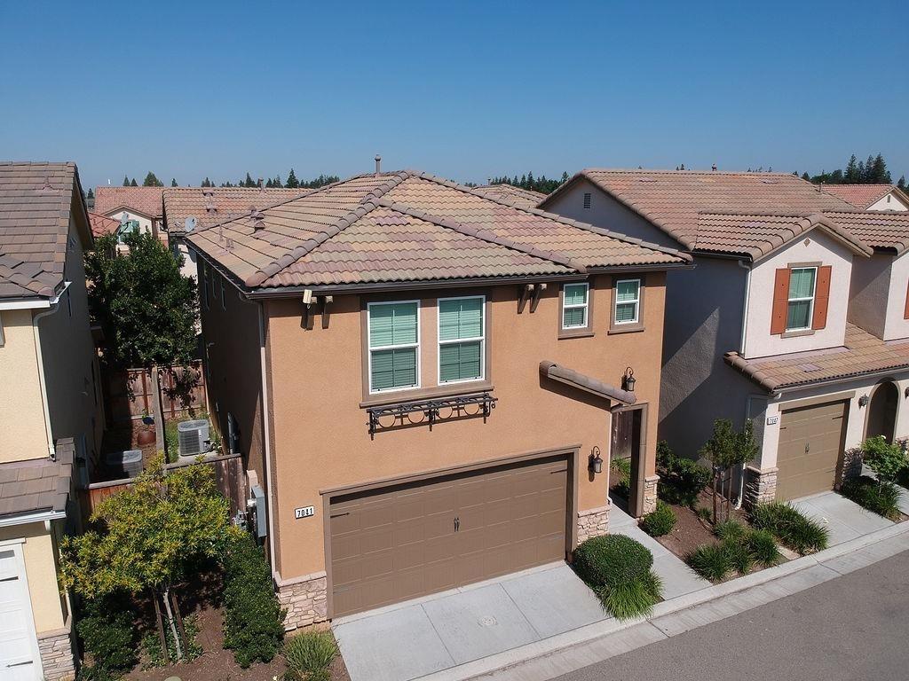 a aerial view of a house with garage and plants