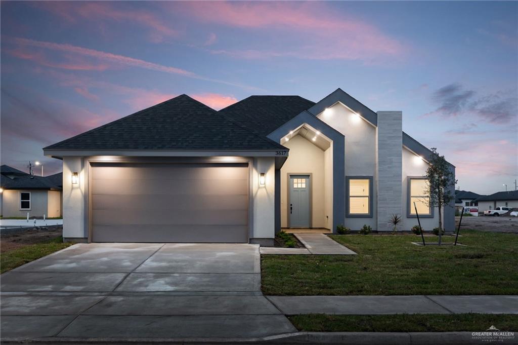 a front view of a house with a yard and garage