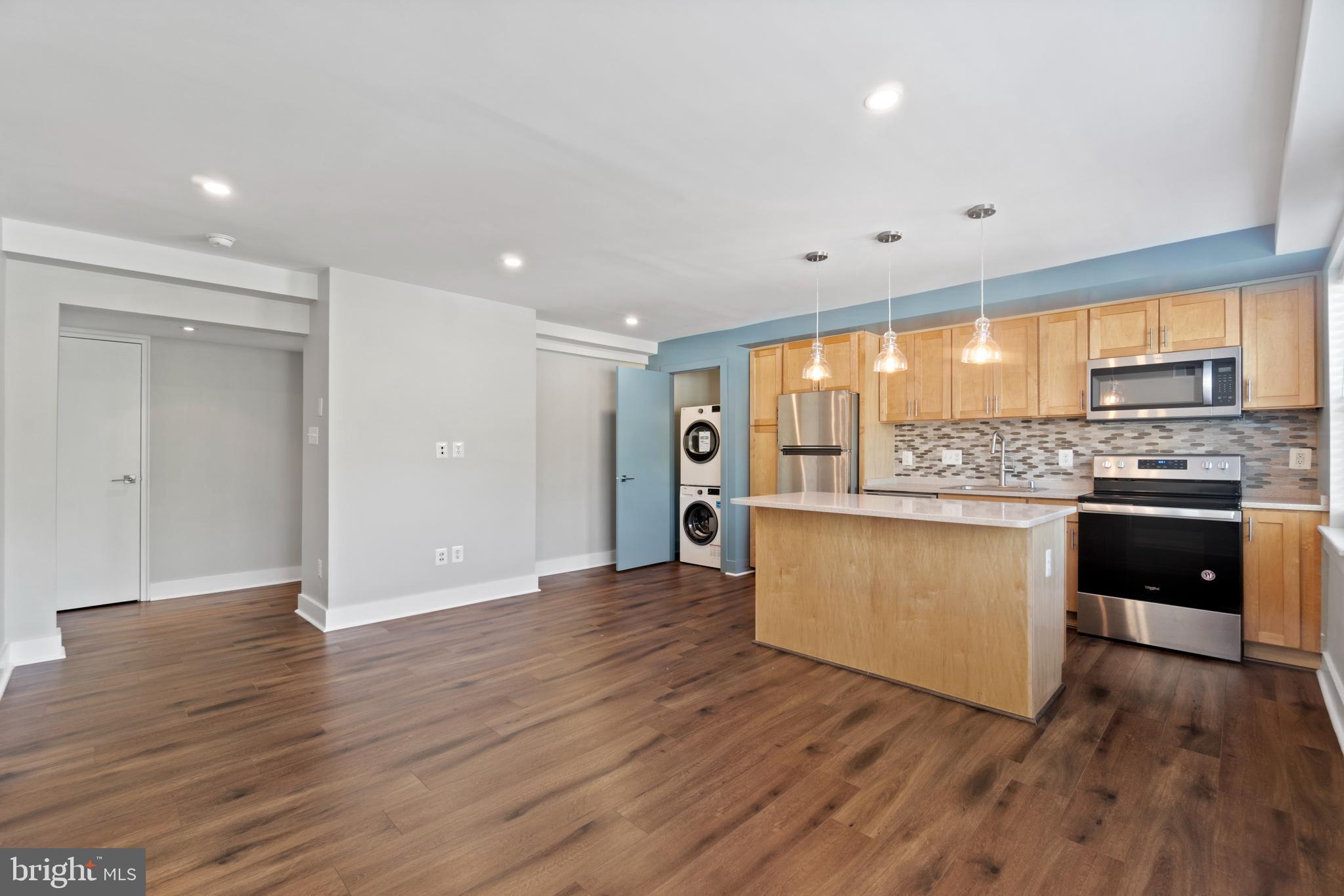 a kitchen with stainless steel appliances granite countertop a stove and a refrigerator