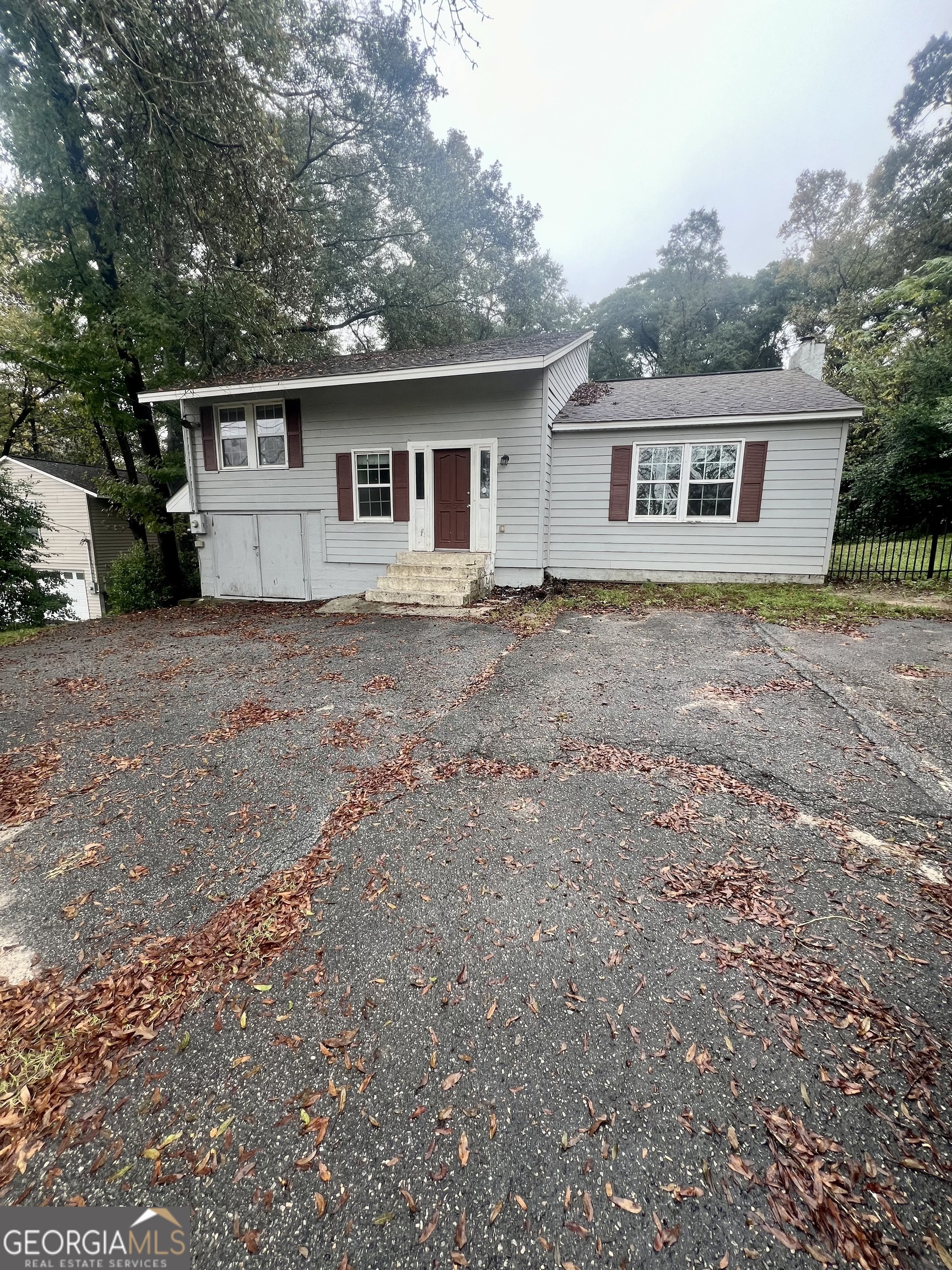 a front view of house with yard and trees