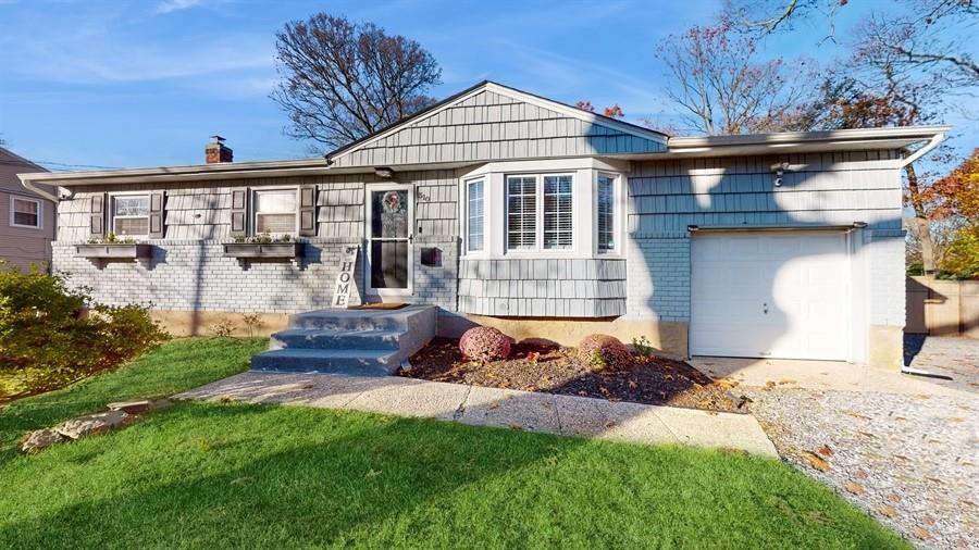 a front view of a house with a yard outdoor seating and garage