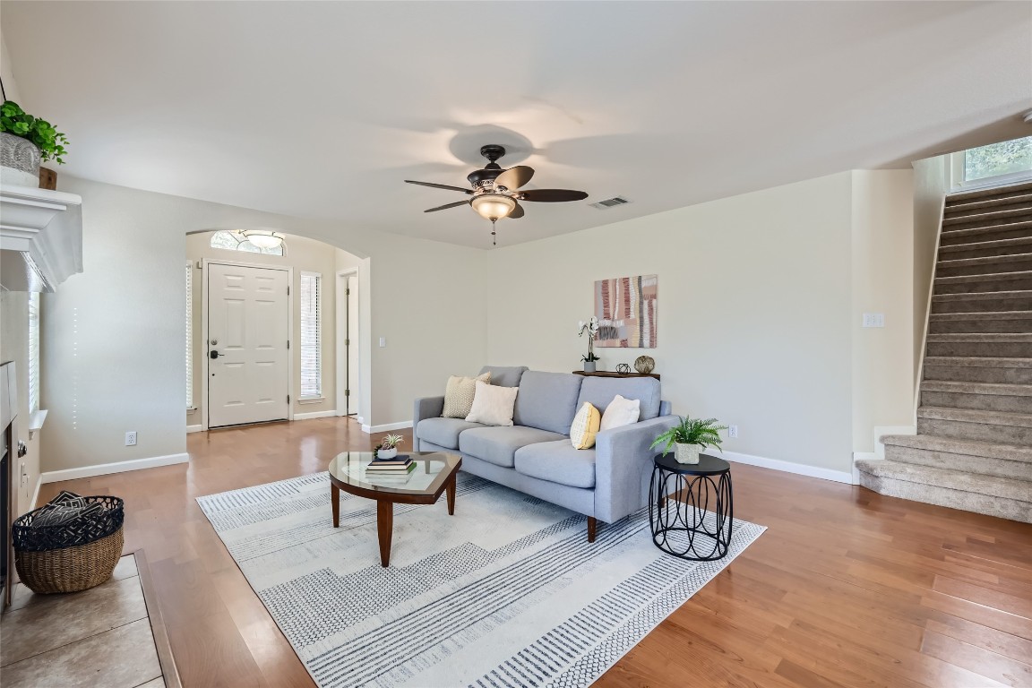 a living room with furniture and wooden floor