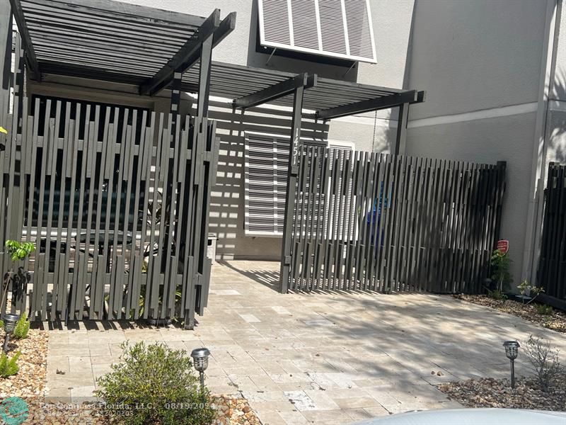 a view of a backyard with wooden fence