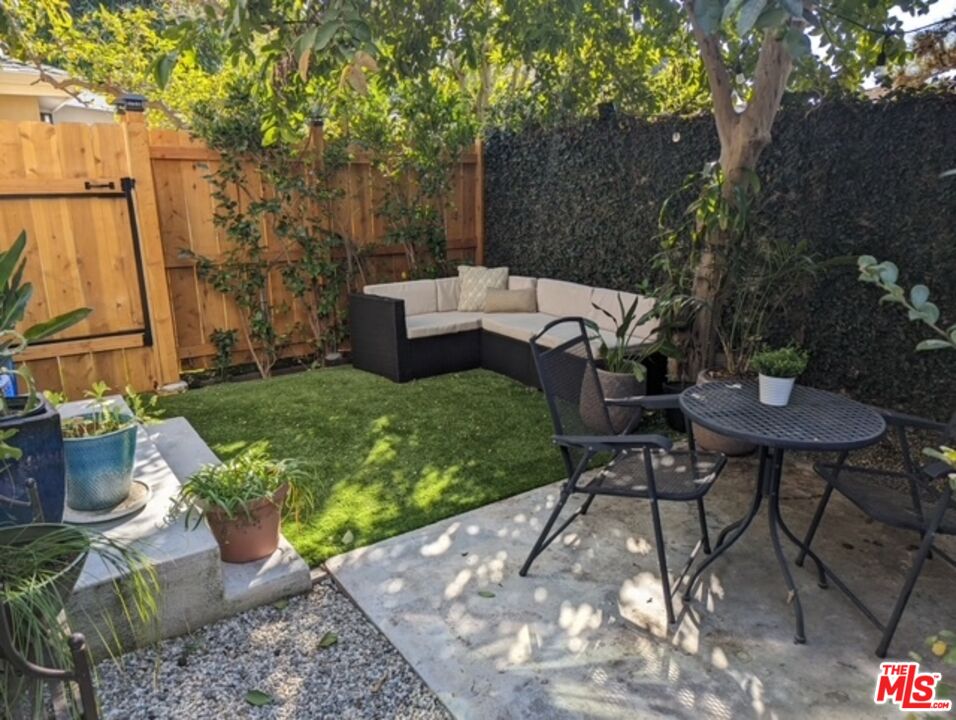 a view of a backyard with table and chairs and a fire pit