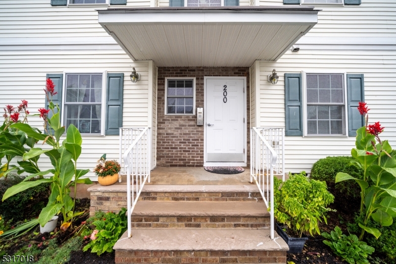 a front view of a house with plants