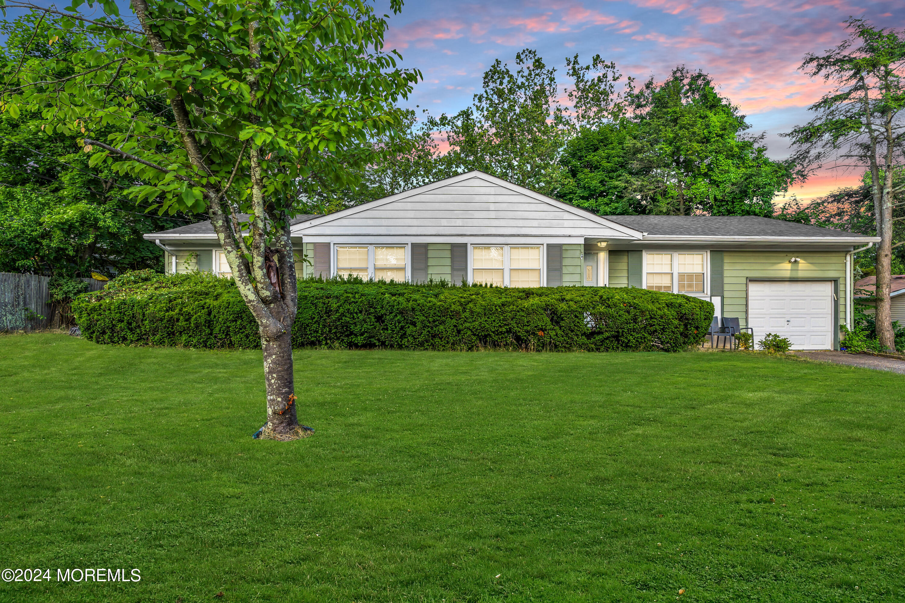 a front view of a house with a garden