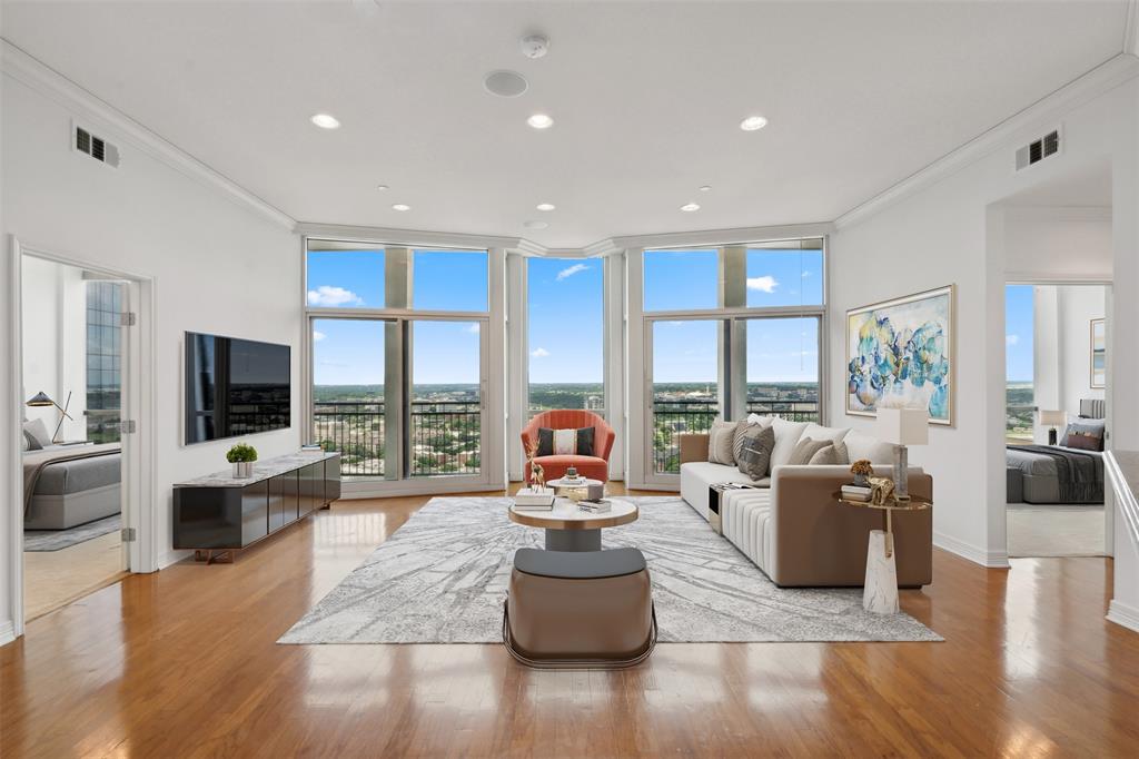 a living room with furniture and large windows