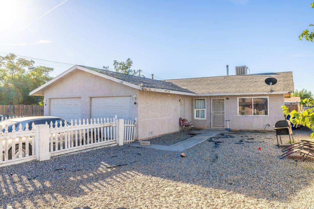 a view of a house with wooden fence