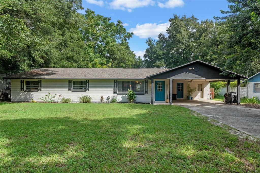 a front view of house with yard and green space