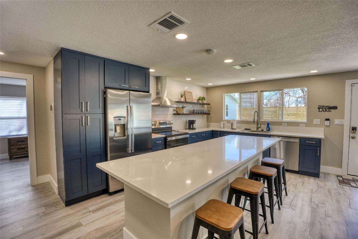 a large kitchen with a table and chairs