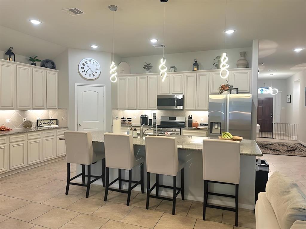 a kitchen with appliances cabinets and furniture