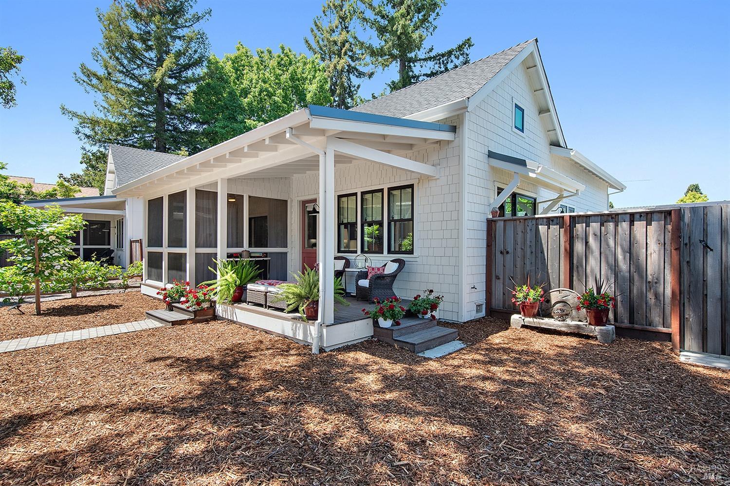 a view of a house with backyard sitting area and garden