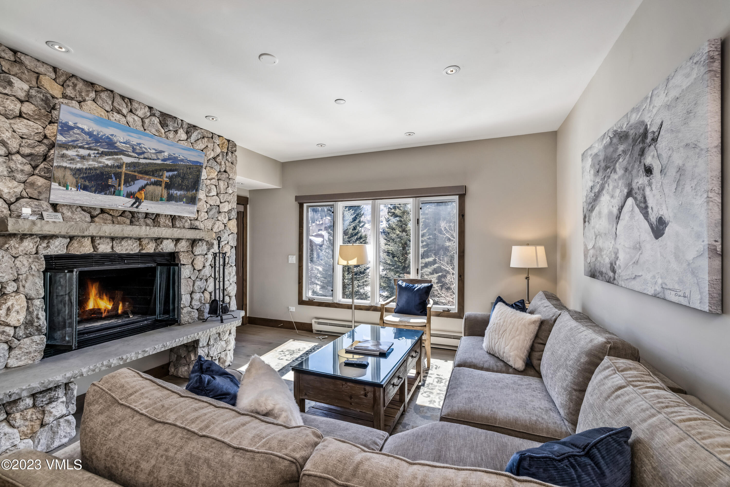 a living room with furniture and a fireplace