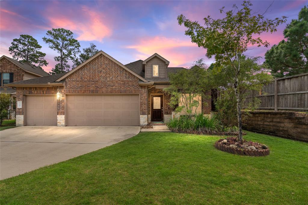 A beautiful single-family brick home featuring a three car garage, and a landscaped front yard, on a cul-de-sac lot.