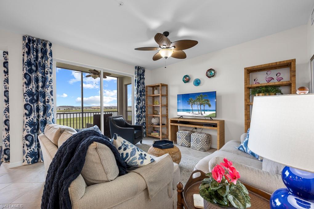 a living room with furniture a flat screen tv and a large window