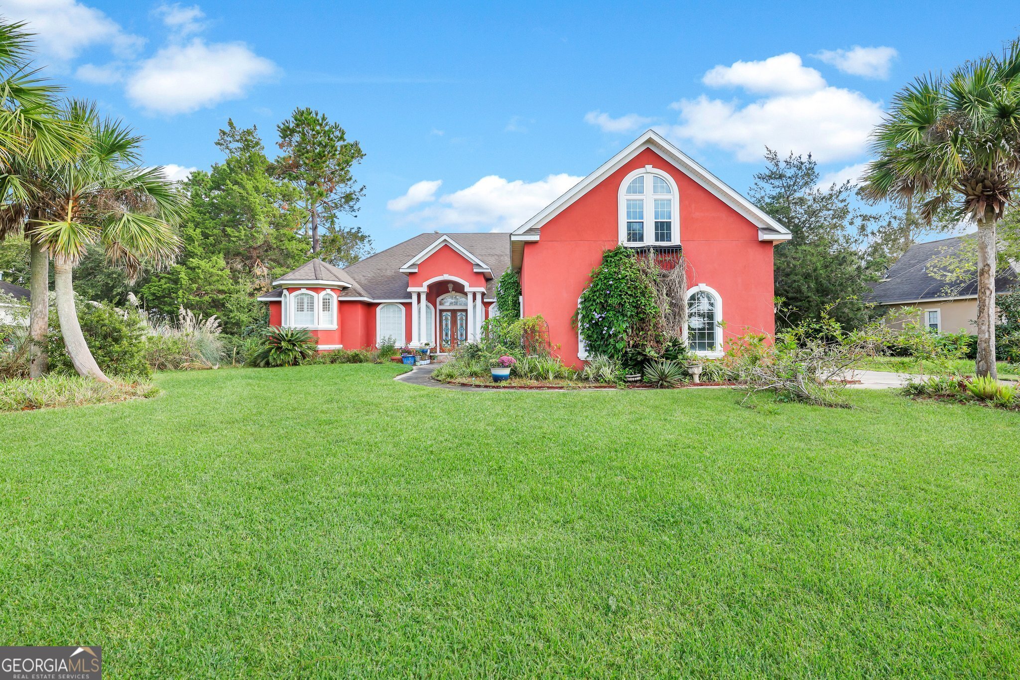 a front view of house with yard and green space