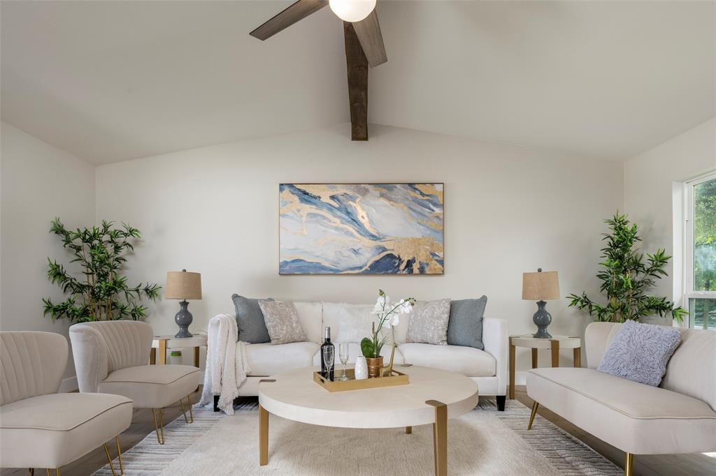 a living room with furniture and a potted plant