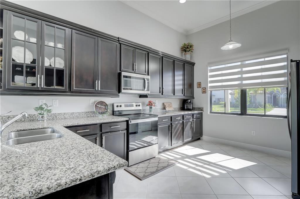 a kitchen with a sink stove and cabinets