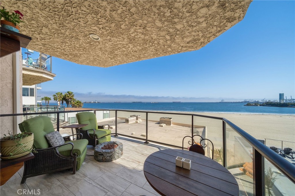 a balcony with wooden floor and outdoor seating