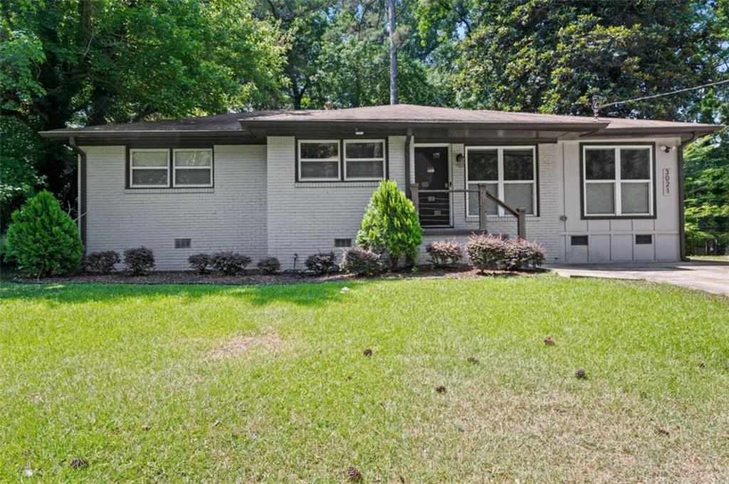 a front view of house with yard and outdoor seating