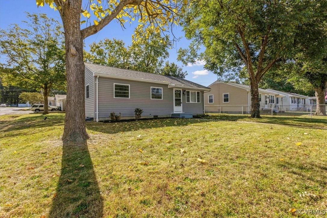 Back of house with a lawn