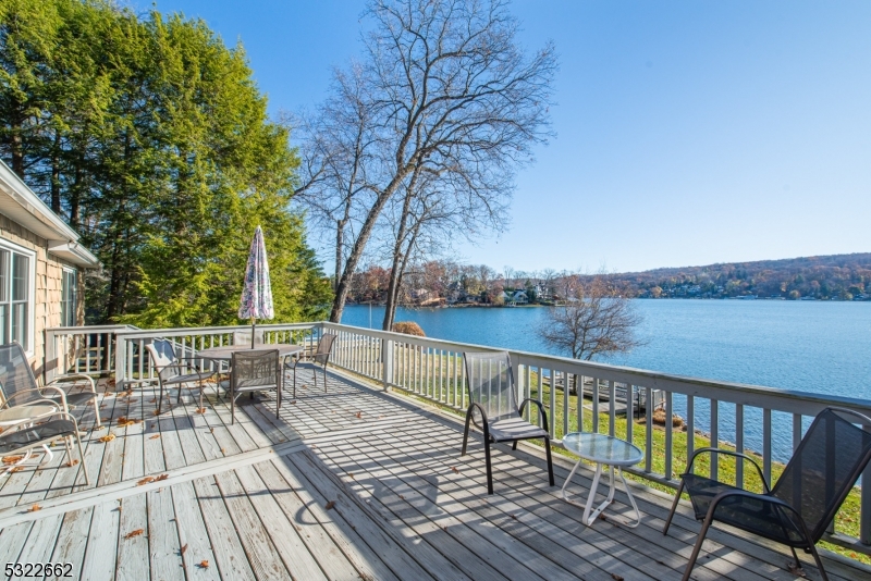 a view of balcony with wooden floor and outdoor seating