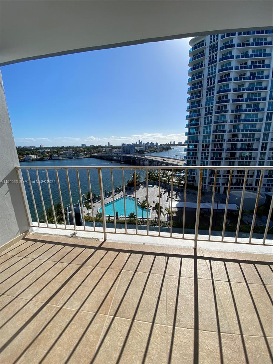 a view of balcony with wooden floor and bench