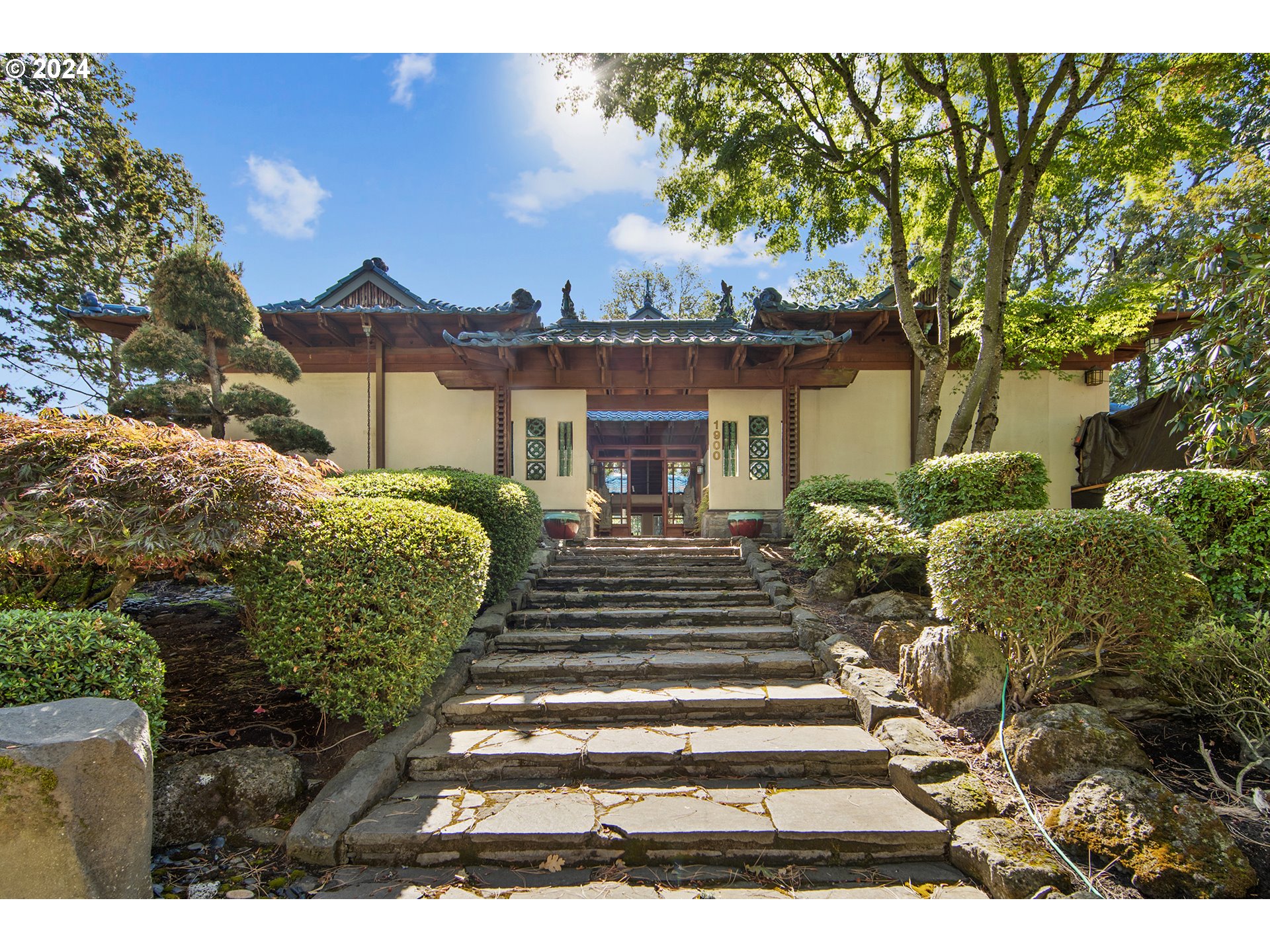 a front view of a house with a garden