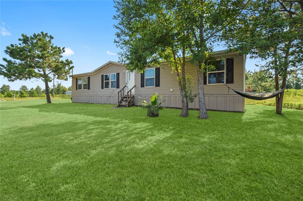 a house view with a sitting space and garden