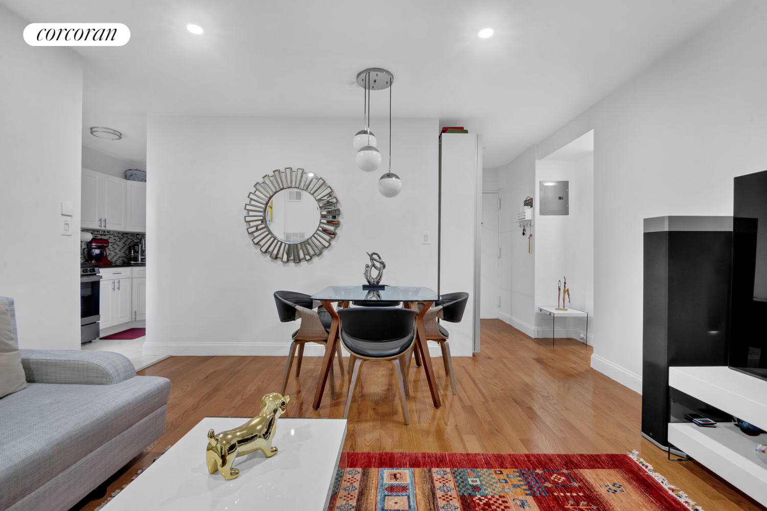 a living room with furniture and a wooden floor