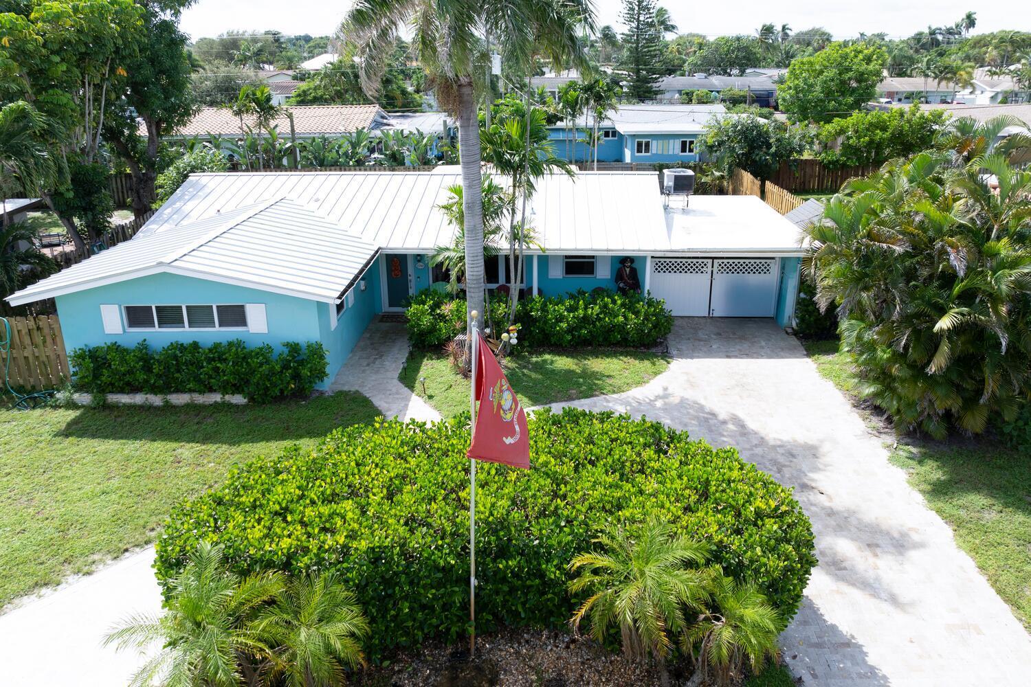 a aerial view of a house with a yard and potted plants