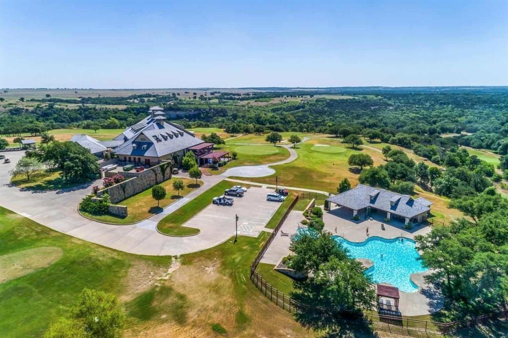 an aerial view of residential houses with outdoor space and swimming pool