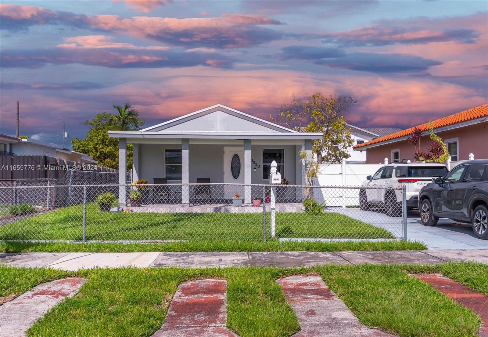 a front view of a house with a garden