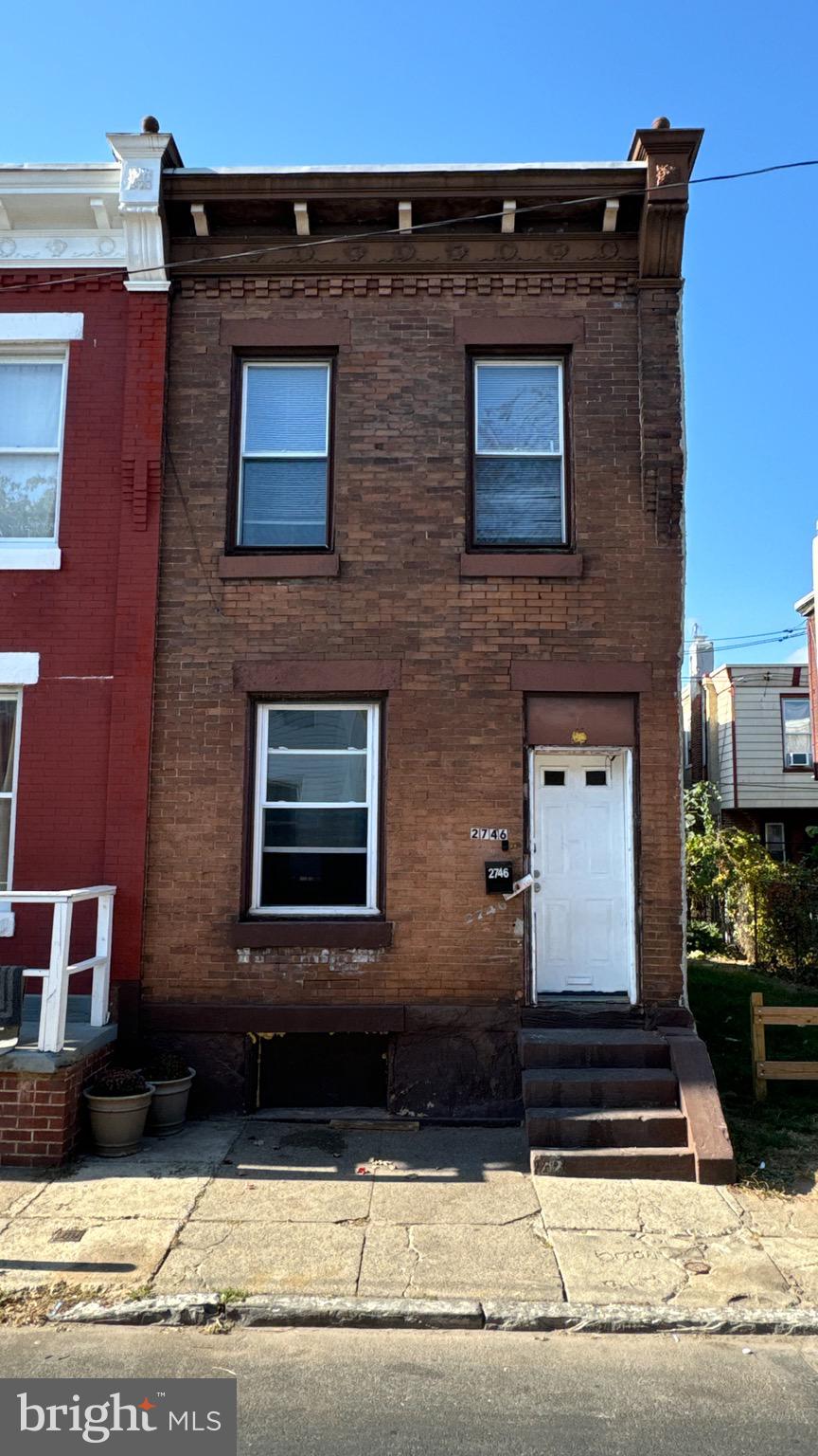 a front view of a house with stairs